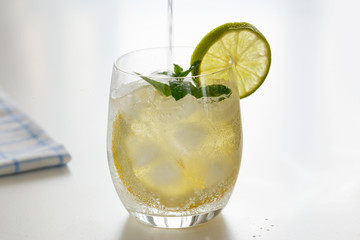 Mineral water with lemon in a steaming glass