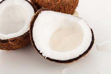 Cracked coconut isolated on white background