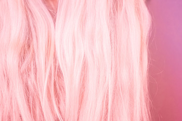 Beautiful pink hair on a pink pastel background.
