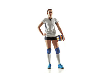 Young female volleyball player isolated on white studio background. Woman in sport's equipment and shoes or sneakers training and practicing. Concept of sport, healthy lifestyle, motion and movement.