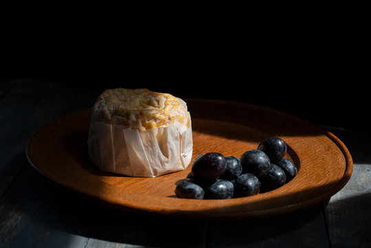 Langres cheese and grapes, dark