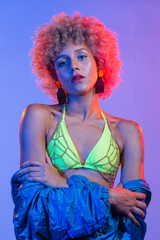 Young black woman in neon colored bikini with afro style hair. 