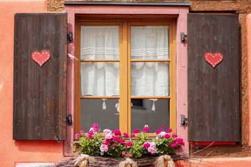 Fototapeta na wymiar Traditional decorated window of half-timbered house in Alsace region