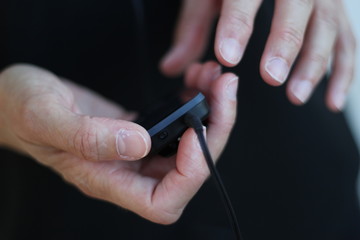 close up of a woman´s hands with a music device during training