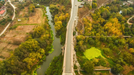 Aerial, top view from Drone. The bridge between the rocks in Kamenetz Podolsky. View of the road from the top. Autumn time.