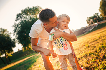 Dad is having fun with the baby in the Park.Boy and father in the Park in summer.Cheerful family