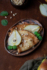 thin crepes with caramel pear and pine nuts