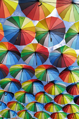 Fototapeta na wymiar Colorful umbrellas background. Lots of umbrellas coloring the sky in the city of Odessa, Ukraine. Street decoration