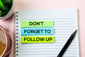 Don't Forget to Follow up text on sticky notes with office desk concept