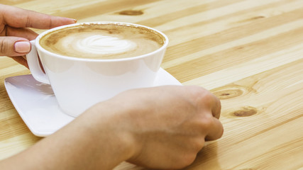 Hands taking cup of coffee