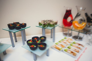 Beautifully decorated catering banquet table with different food snacks and appetizers on corporate, christmas, birthday party event or wedding celebration