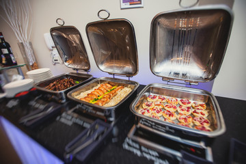 Beautifully decorated catering banquet table with different food snacks and appetizers on corporate, christmas, birthday party event or wedding celebration