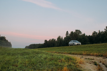 sunset over green field
