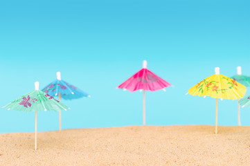 Umbrellas on the sandy beach. Tropical vacation background. Copy space, top view.