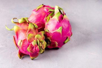 Three Tasty Dragon Fruit on Gray Background Sweet Tropical Fruit Pitaya Horizontal Copy Space