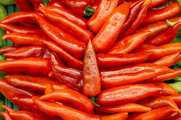 Red sweet pepper background with stacked peppers layed specially for buyer attraction.