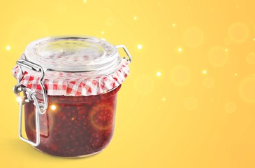 Glass jar with raspberry jam isolated on the white background