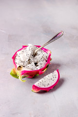 Cube of Dragon Fruit Served in Half a Dragon Fruit on Gray Background Tasty Tropical Fruit Pitaya Vertical