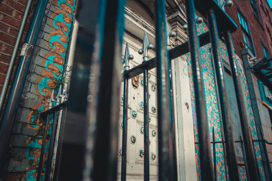 Shot from below of an iron gate in front of a door.