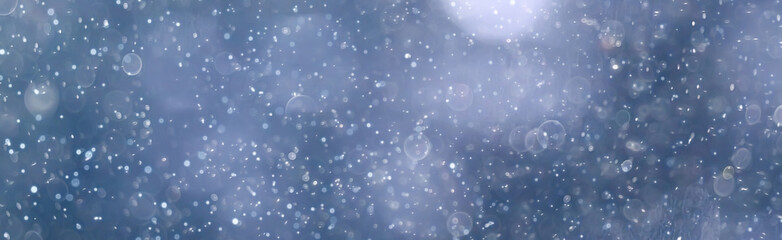 city lights snow glow background blurred / cityscape blurred bokeh, snowy weather seasonal background winter December