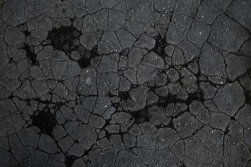 asphalt in cracks texture / abstract background cracks on asphalt road