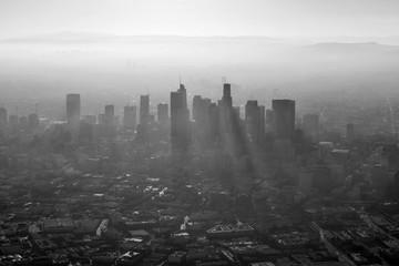 Aerial black and white view of thick summer smog in urban downtown Los Angeles, California.