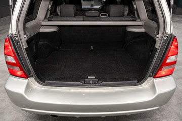 Close up Rear view of a SUV  gray car with open trunk in garage. Empty car trunk