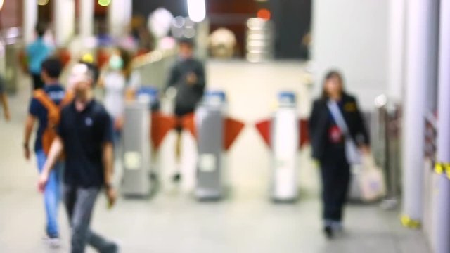 blurry of many people walking pass door access control. ticket automate in a BRT station at Bangkok, Thailand.