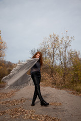 Young redhead woman with scarf in autumn park 