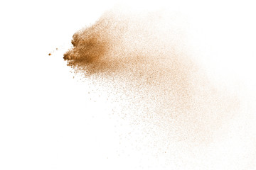 Explosion of brown powder on white background.