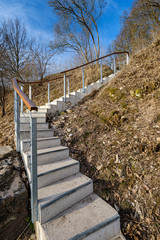 wooden stairs up the hill in countryside forest