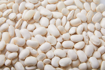  White kidney bean seeds background. Cannellini beans texture background. Close-up shot