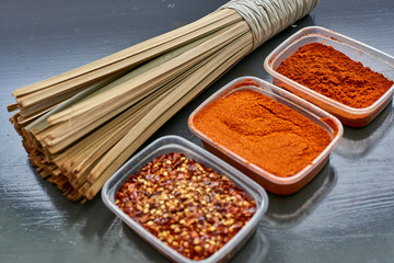 Spices in plastic containers with bamboo brush