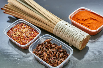 Spices in plastic containers with bamboo brush