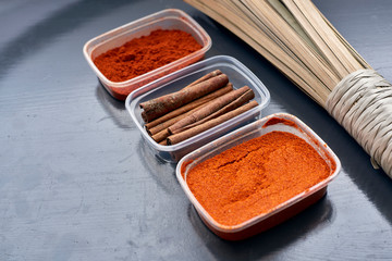 Spices in plastic containers with bamboo brush