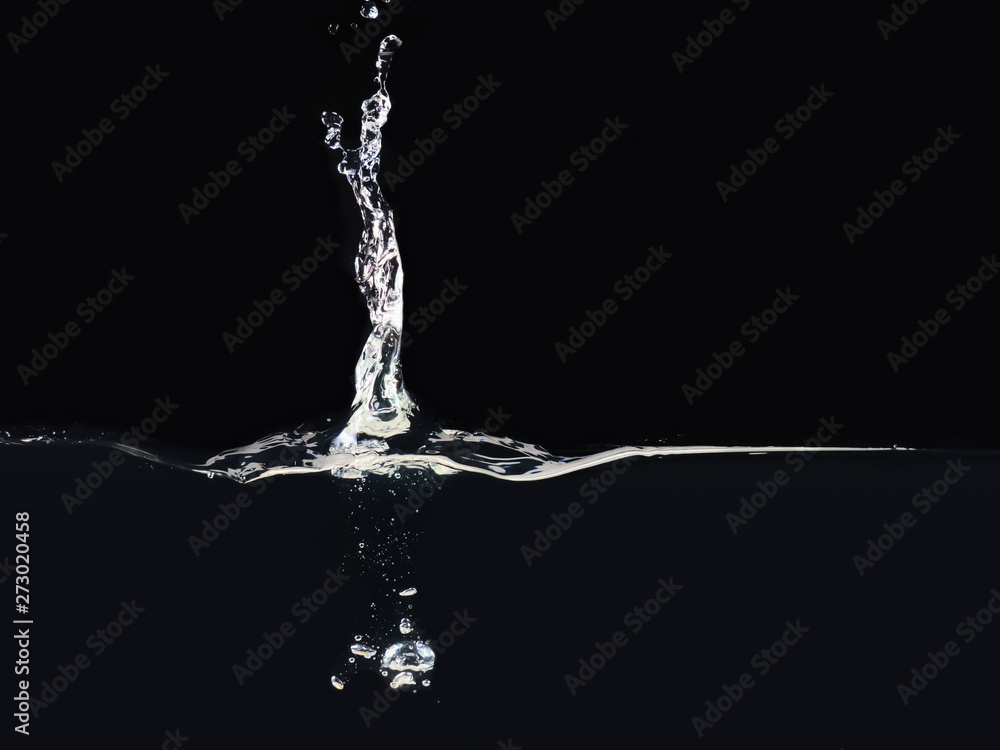 Poster splash on water surface isolated on black background, close up view. drop falling into liquid. bubbl