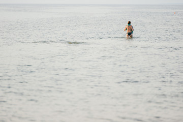 Fototapeta na wymiar Unrecognizable female crossing the sea