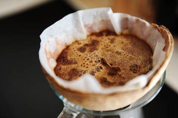 Unusual creative coconut shell pourover drip alternative coffee brewing close up