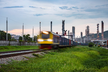 Fototapeta na wymiar refinery oil and petroleum industry factory zone and containers train open light movement foreground with background sky in the rain season