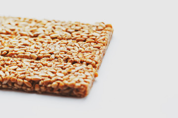 Healthy snacks. Fitness diet food. Kozinaki fritter, seeds, energy bars. White background top view. Isolate, Copy Space