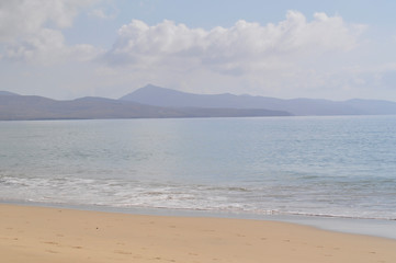 Sandy ocean beach with mountains in background. Costa Calma, Fuerteventura, Canary Islands