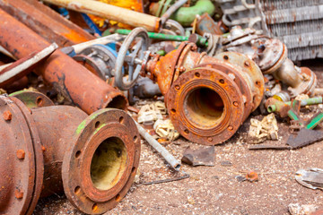 Fototapeta premium Various aged rusted parts of obsolete equipment at junkyard