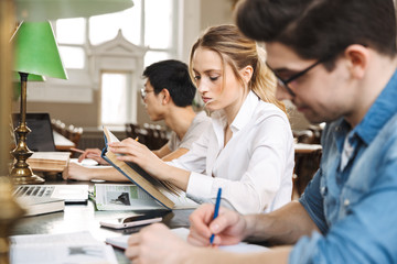 Group of smart young students studying hard