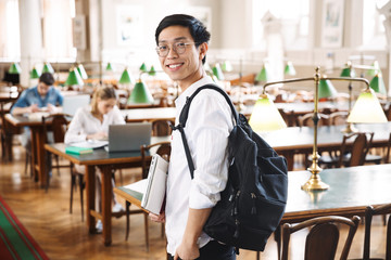 Fototapeta na wymiar Smiling asian teenager student studying