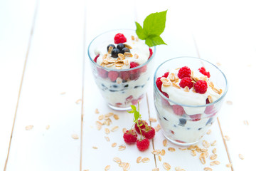 Healthy layered dessert with cream, muesli, currants and raspberries