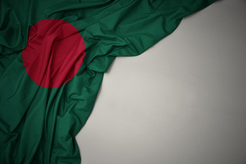 waving national flag of bangladesh on a gray background.
