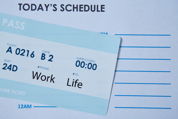 Work life balance choice concept. boarding pass on the schedule sheet.