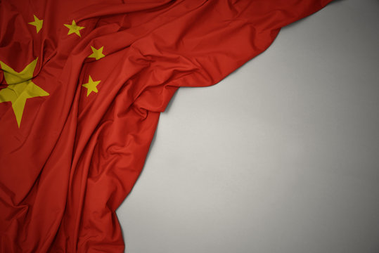 waving national flag of china on a gray background.