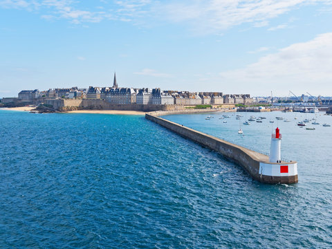 Sailing past the long jetty in the French port of St Malo in the morning sunshine.