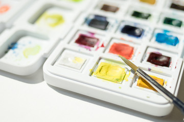 Colorful watercolor in a white plastic box